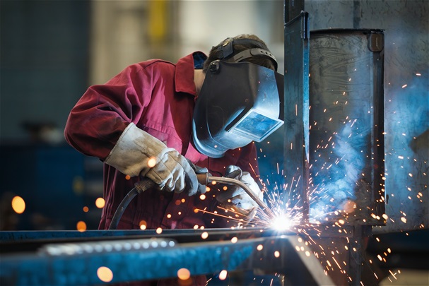 person welding with mask