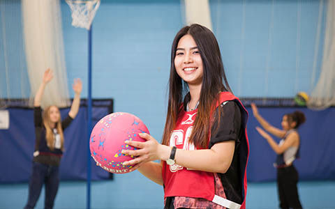 Sport student holding a basketball
