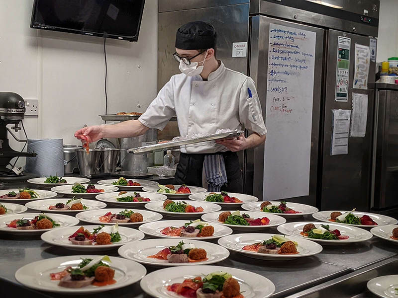Student preparing meals in the professional kitchen