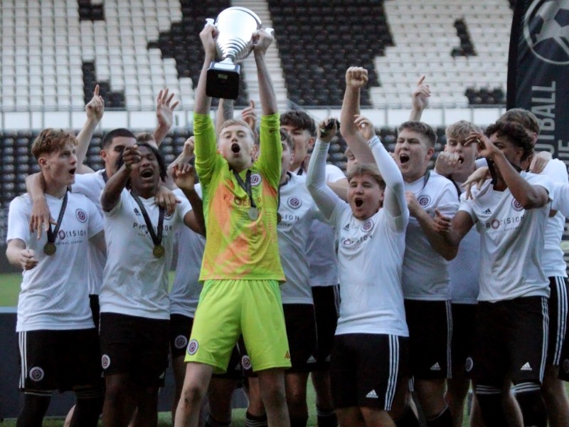 Donny Burke and teammates lifting the trophy